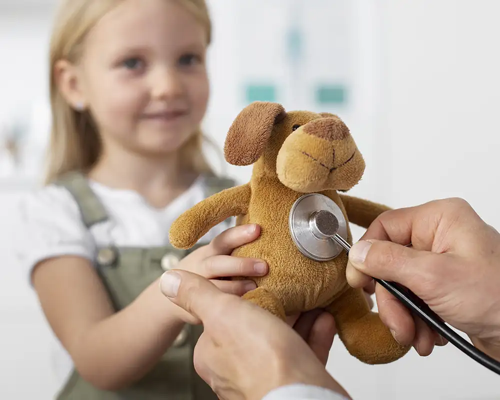 little girl with stuffed animal and stethescope